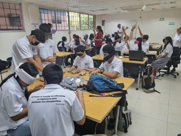 Students working in class while wearing blindfolds